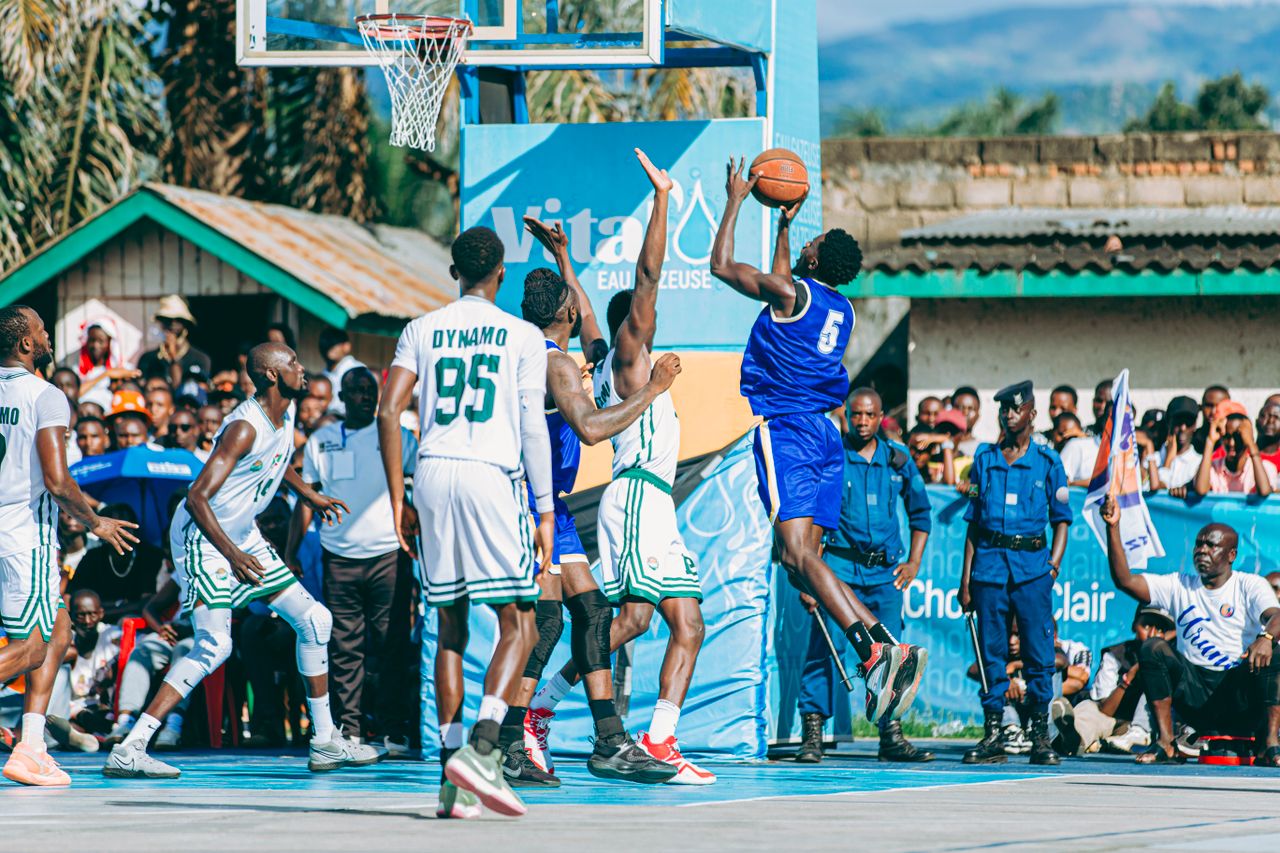 Basketball players in action during an outdoor game, showcasing athletic skill and teamwork.