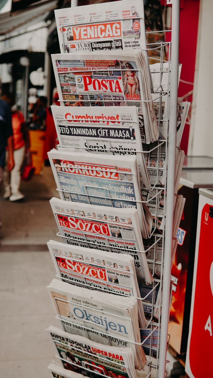 Close-up of various Turkish newspapers on a street stand, capturing daily life.